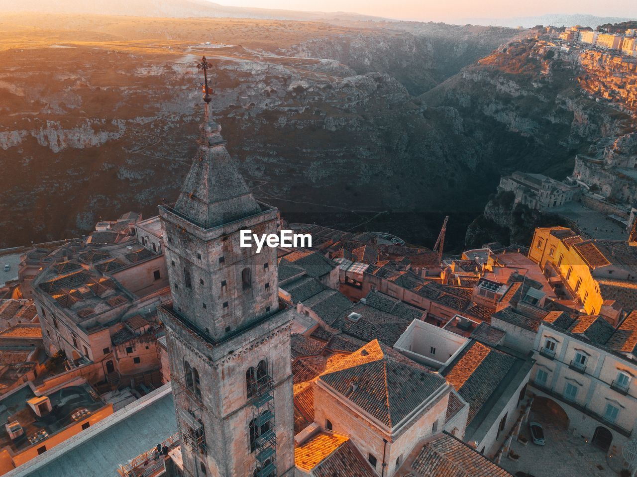 Aerial view of buildings in city during sunset