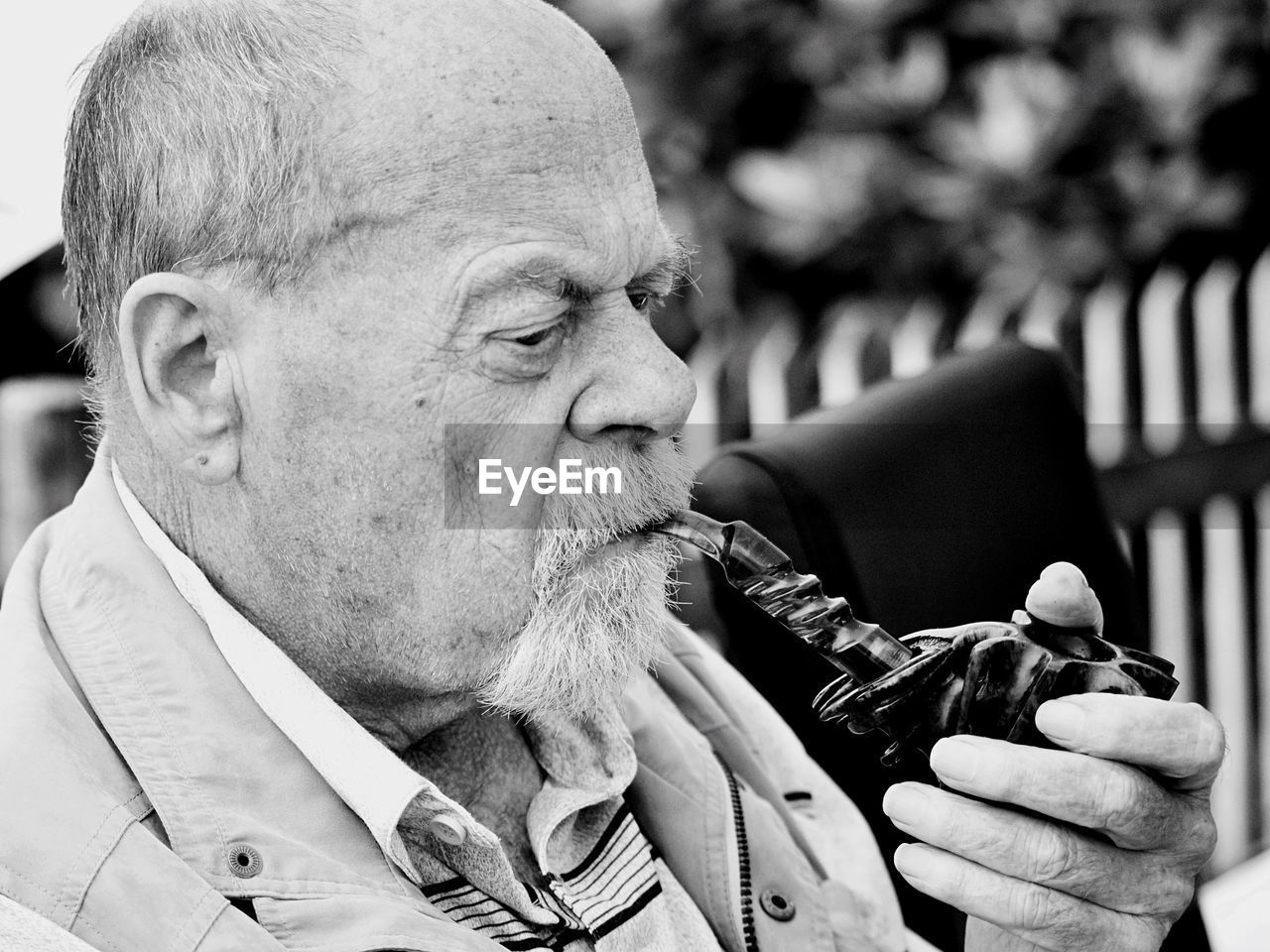 Close-up of man smoking pipe cigarette