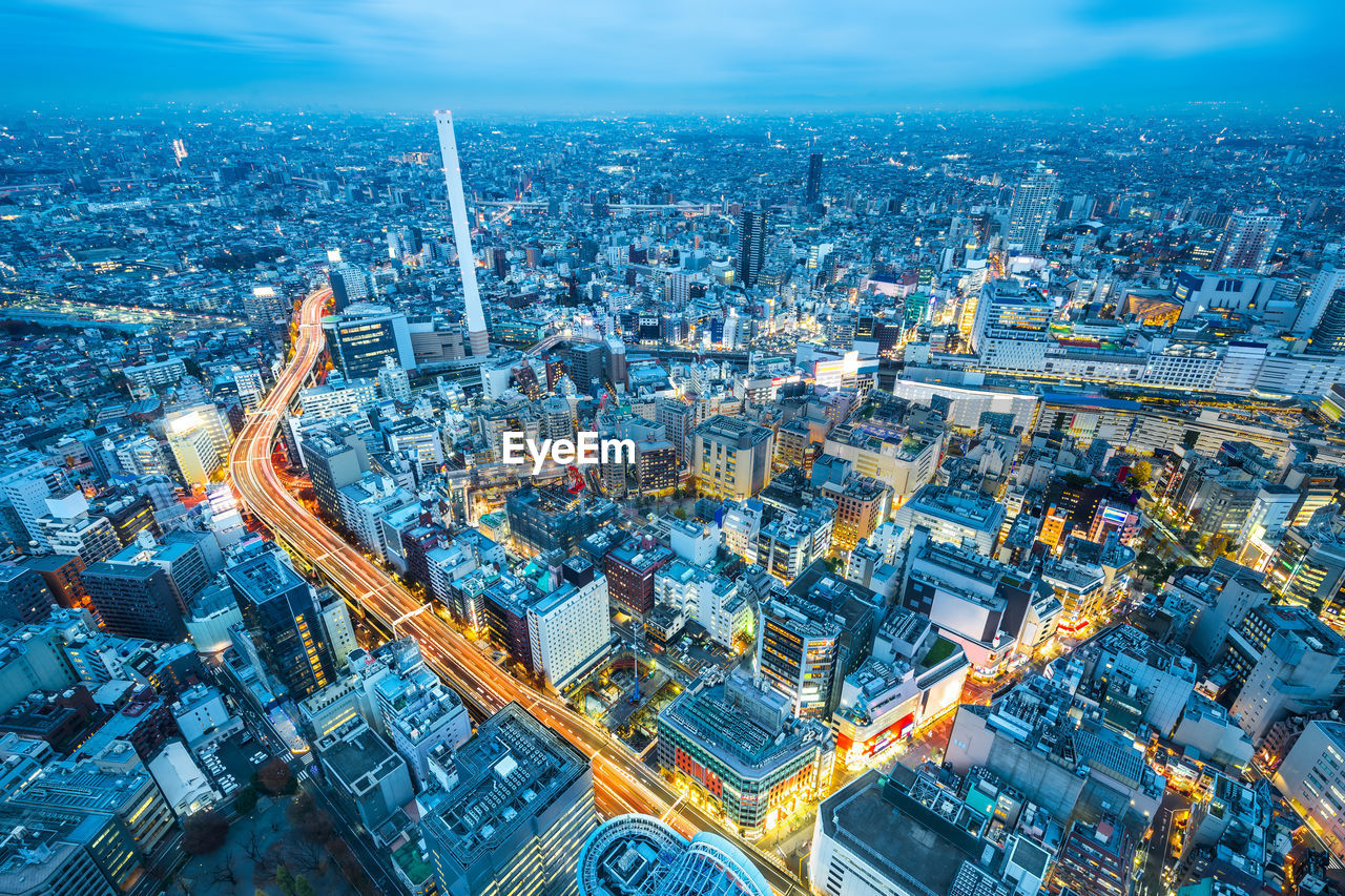 High angle view of illuminated modern buildings in city at night