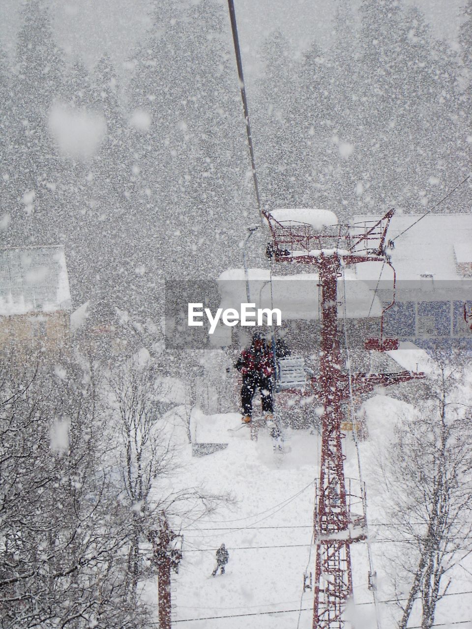 Person on ski lift during snowfall