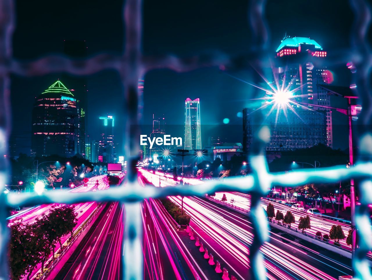 High angle view of illuminated light trails on building at night