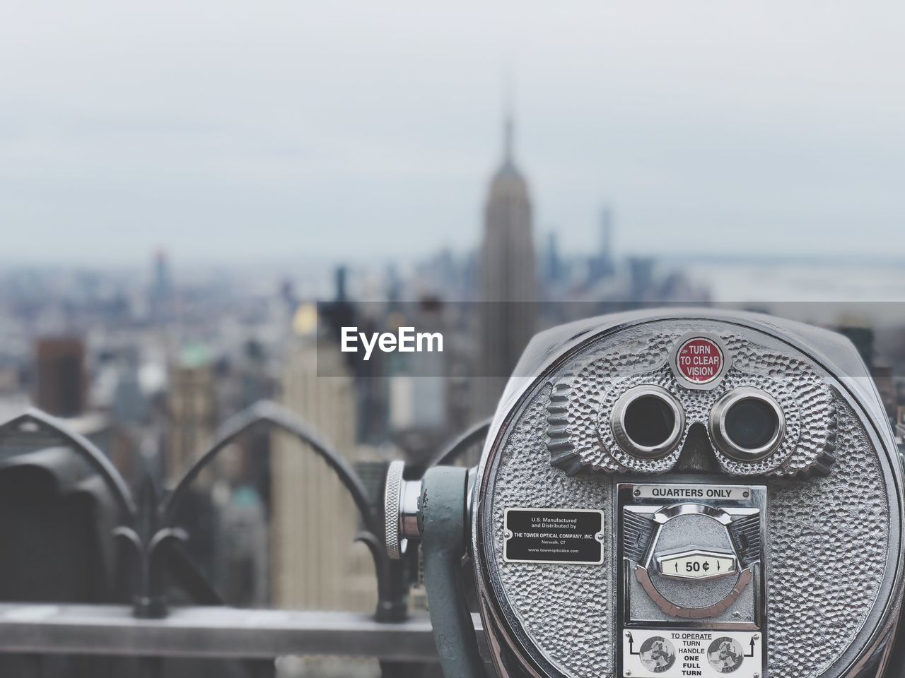 CLOSE-UP OF COIN-OPERATED BINOCULARS ON CITY BUILDINGS