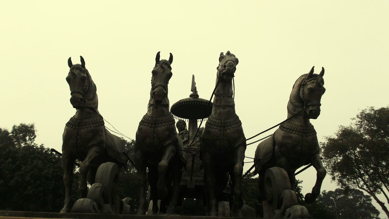 LOW ANGLE VIEW OF STATUES AGAINST SKY