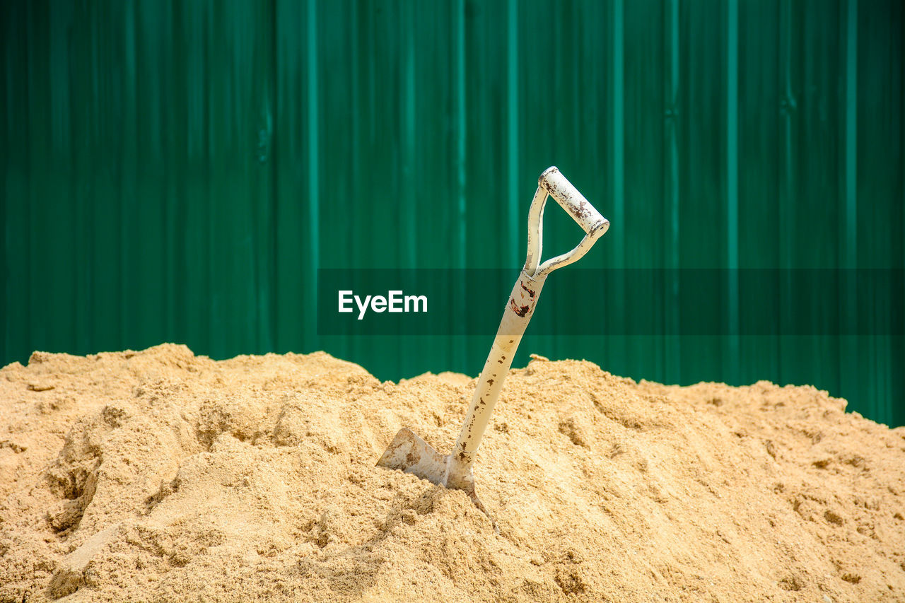 Close-up of shovel in sand