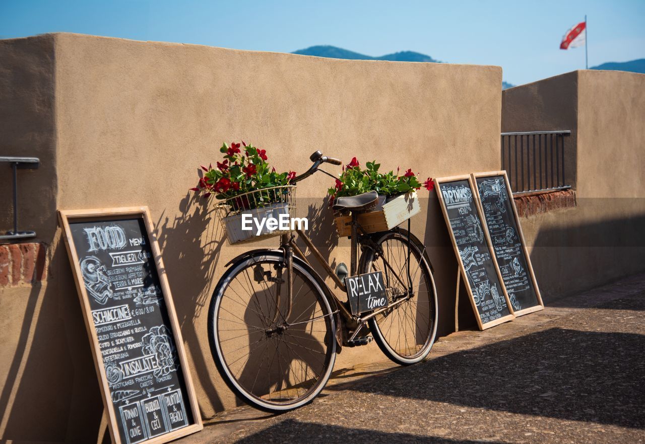 Bicycle leaning on wall in city