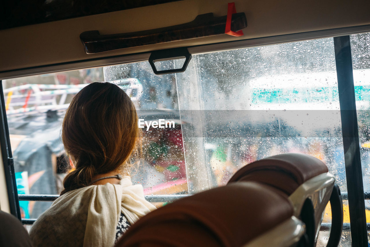 Rear view of woman traveling in bus