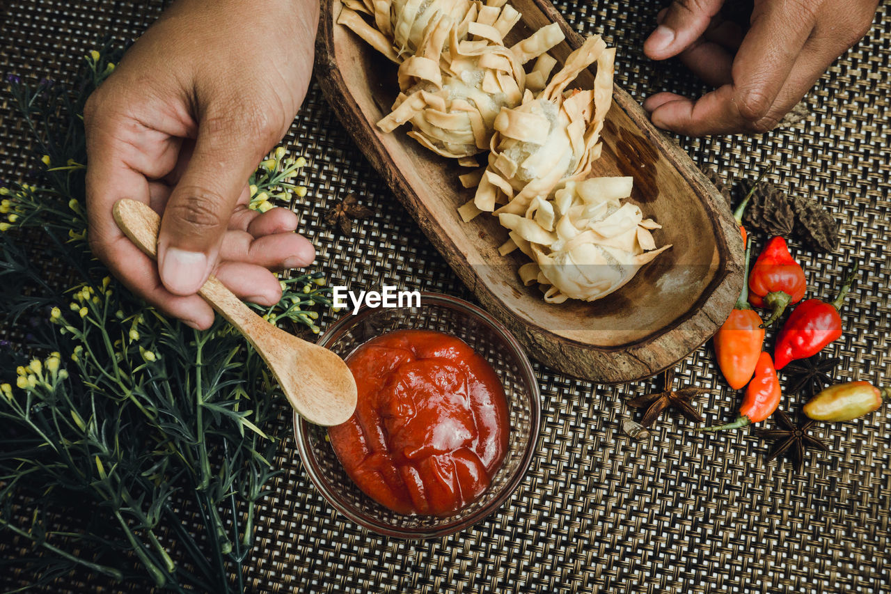 cropped hand of person preparing food on field