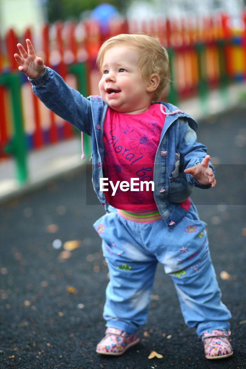 Full length of cute baby girl standing on road