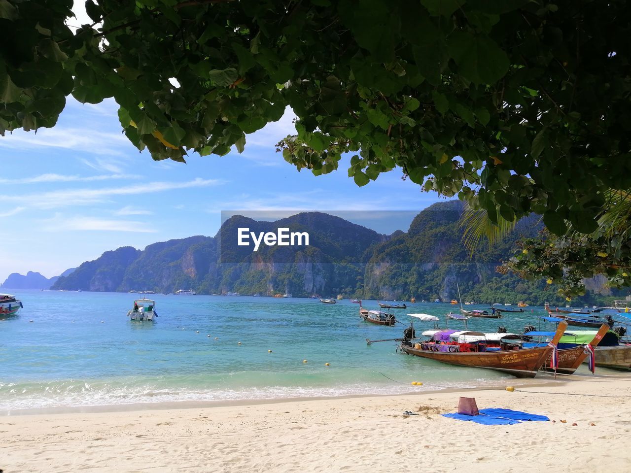 BOATS ON BEACH AGAINST SKY