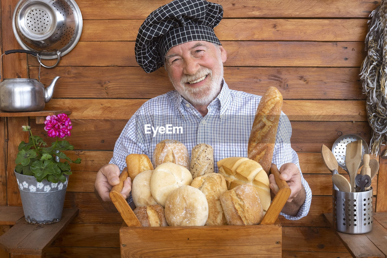 Portrait of man holding bread in container