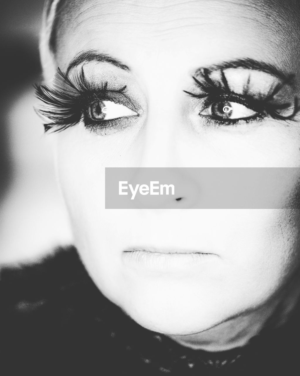 Close-up of thoughtful woman wearing false eyelashes outdoors