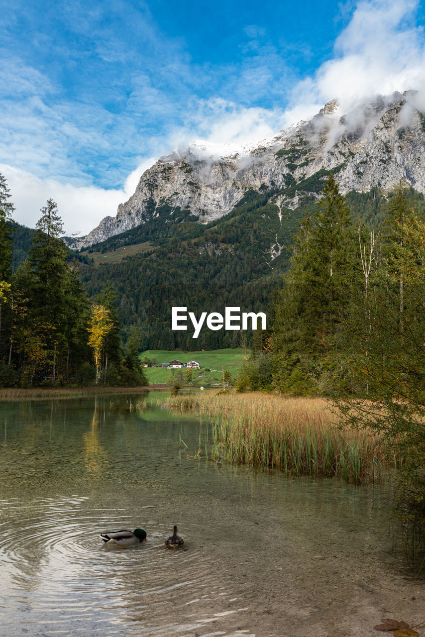 SCENIC VIEW OF LAKE AGAINST MOUNTAIN RANGE