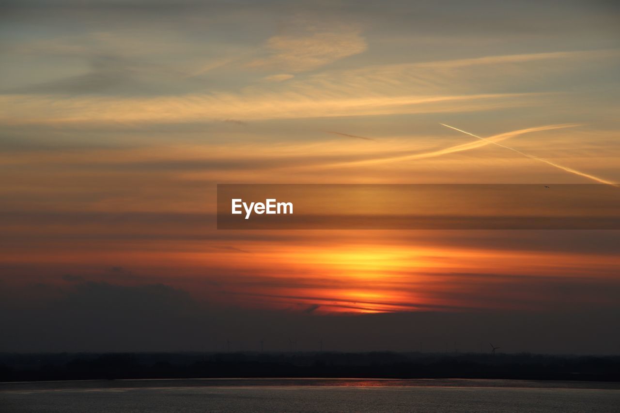 Scenic view of sea against romantic sky at sunset