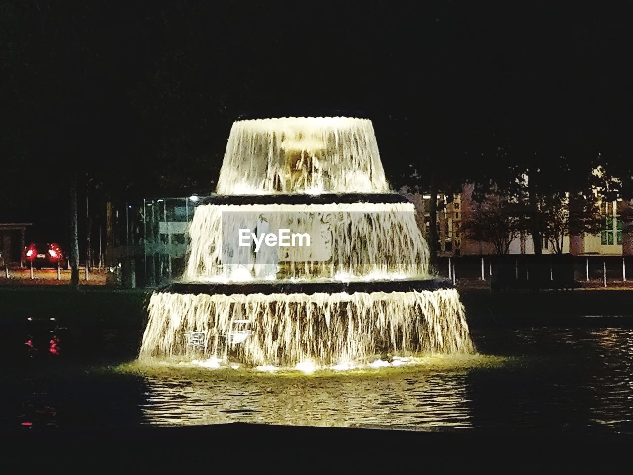 WATER FOUNTAIN IN FRONT OF SEA AT NIGHT