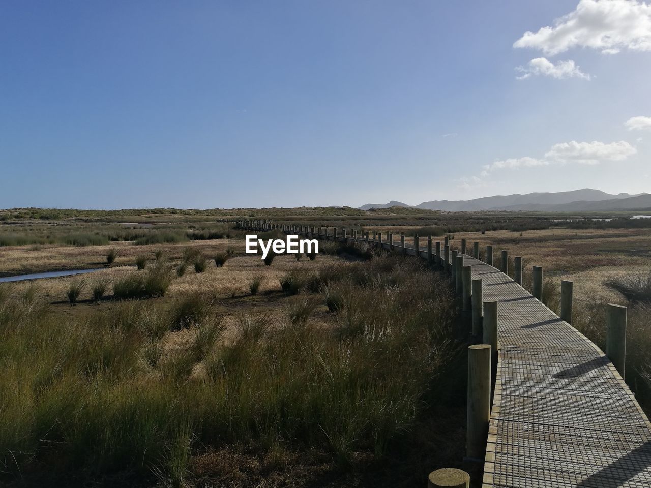 SCENIC VIEW OF LANDSCAPE AGAINST CLEAR SKY AND CLOUDS