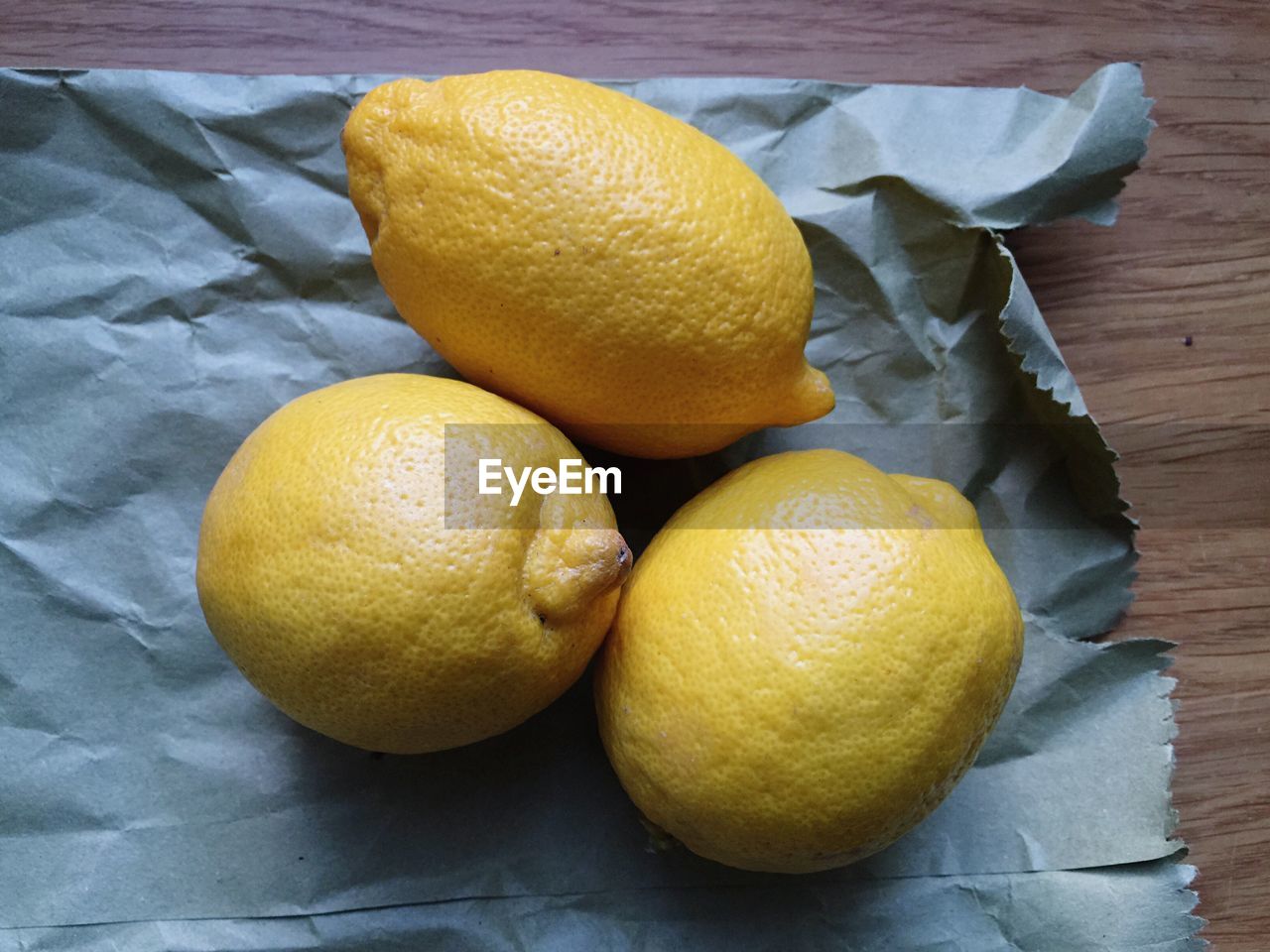 High angle view of lemons on paper on table