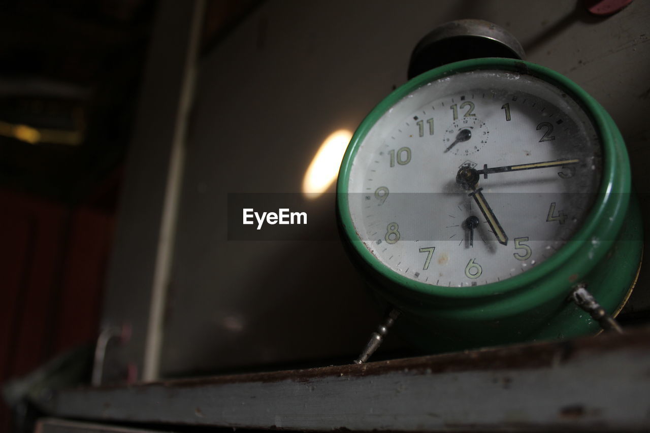 Close-up of clock on shelf