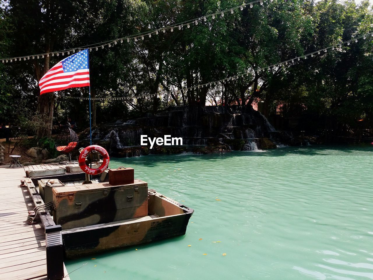 Scenic view of flag against trees