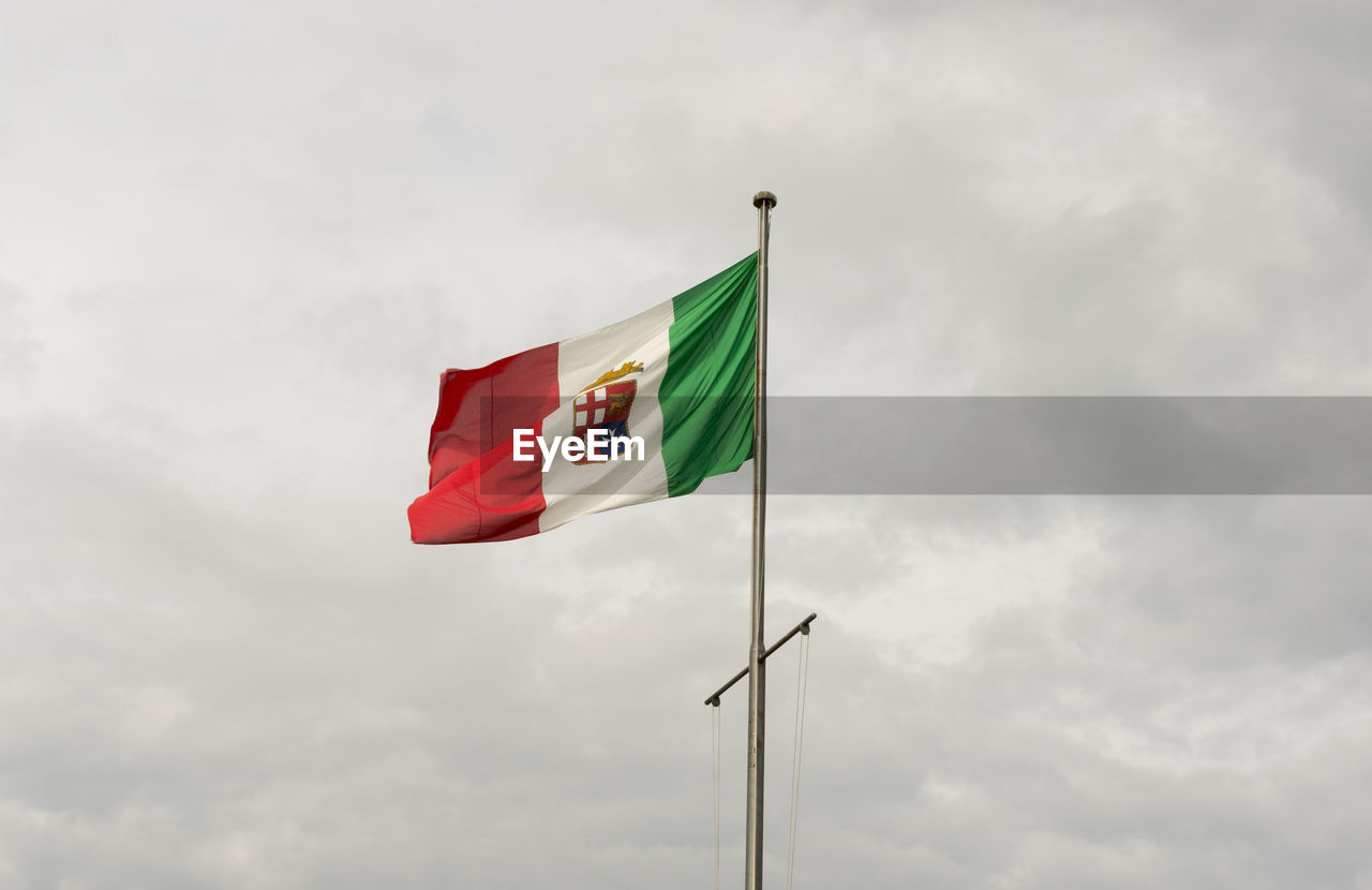 Low angle view of flag against sky