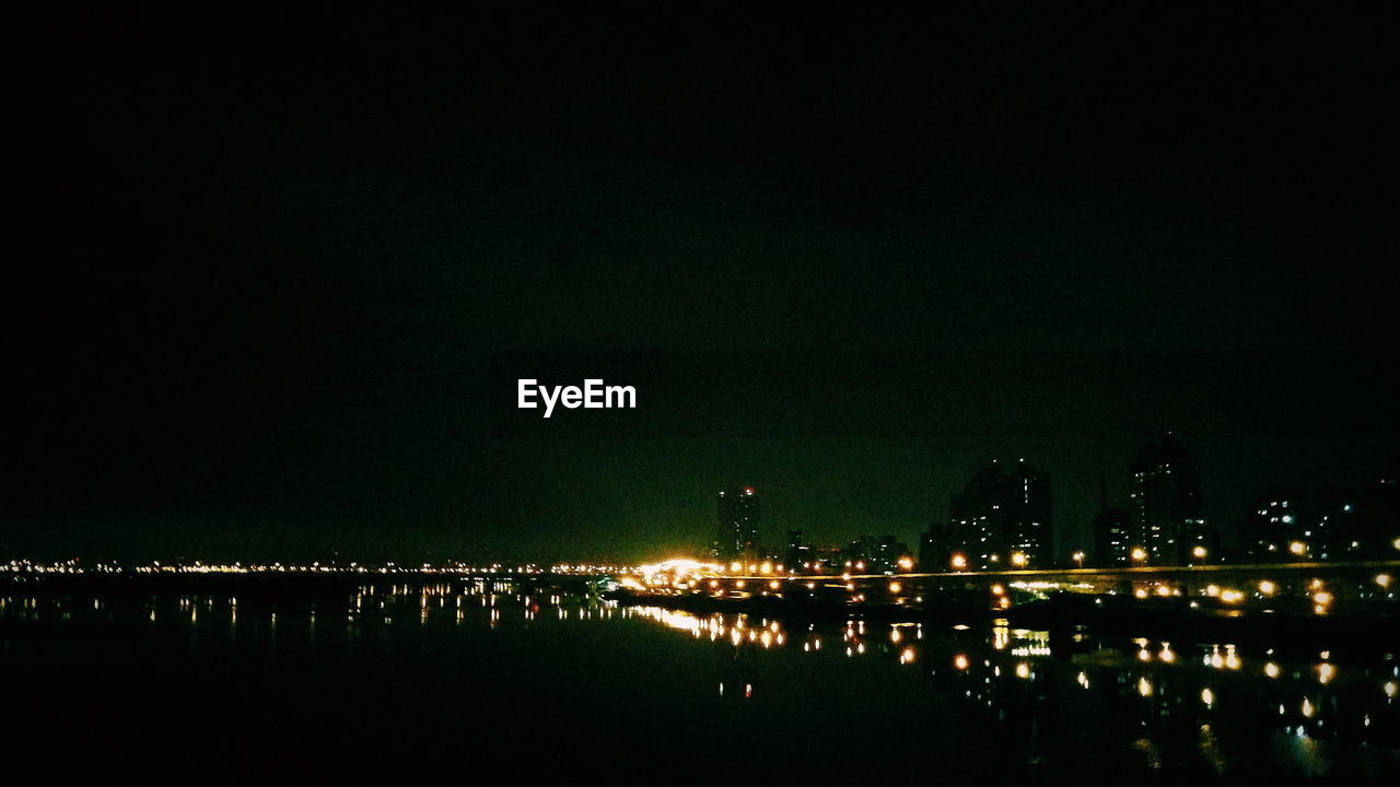 REFLECTION OF ILLUMINATED BUILDINGS IN WATER