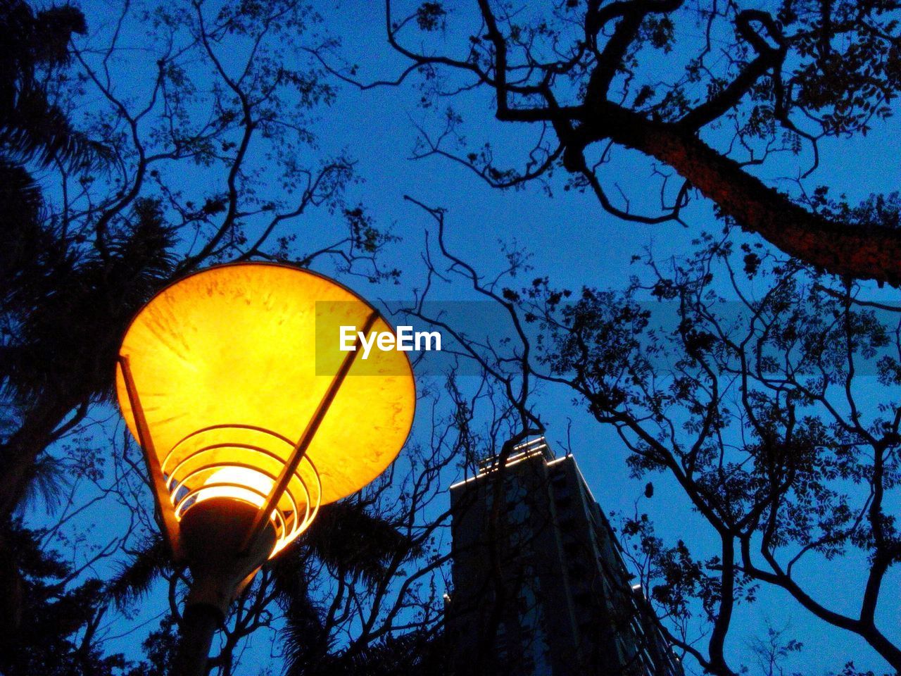 Low angle view of illuminated lantern against clear sky