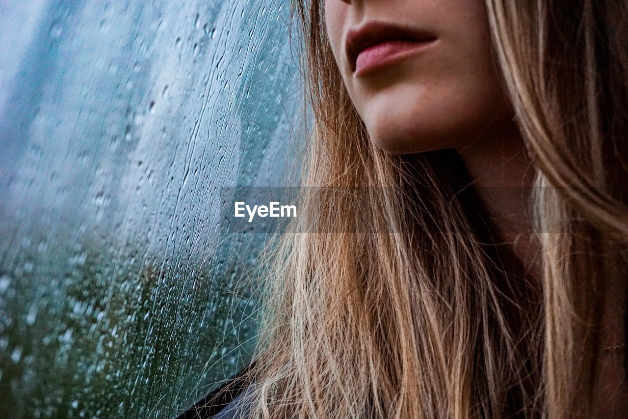 Close-up portrait of a beautiful woman in rainy day