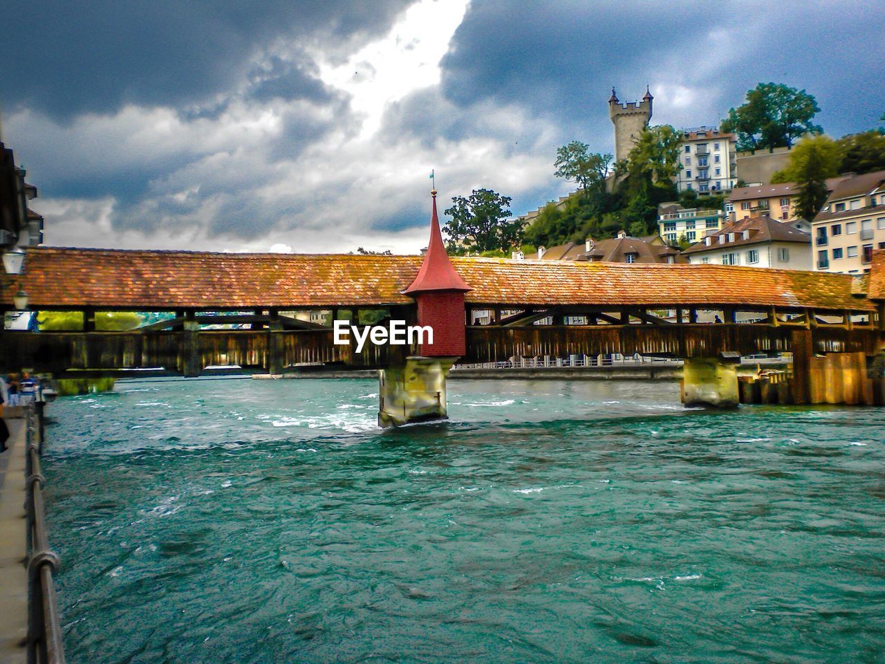 RIVER WITH BUILT STRUCTURES IN BACKGROUND