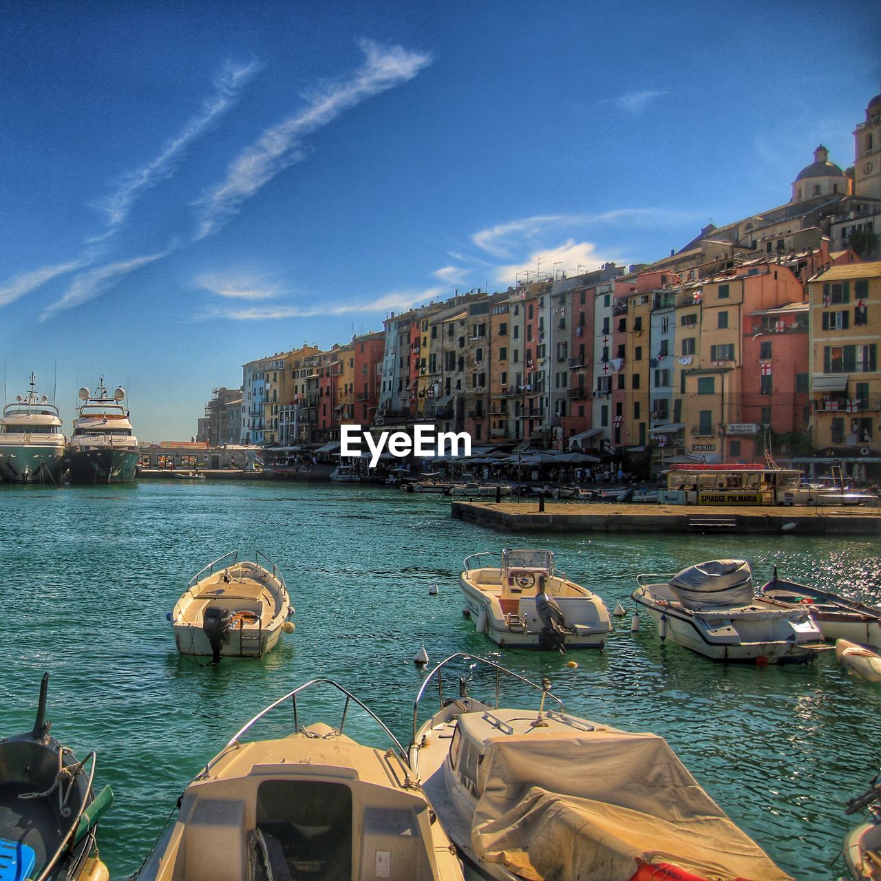 Boats in canal with buildings in background