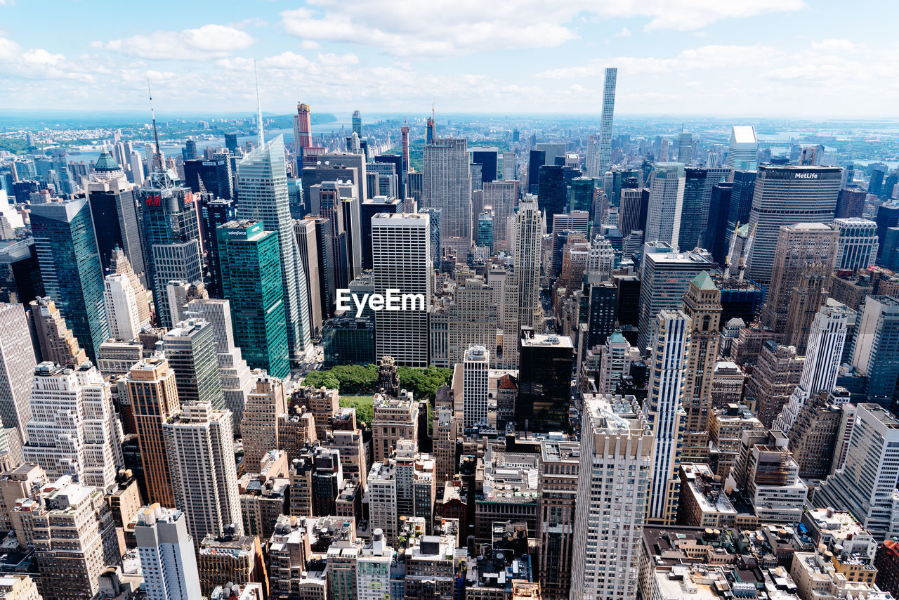 High angle view of modern buildings in city against sky