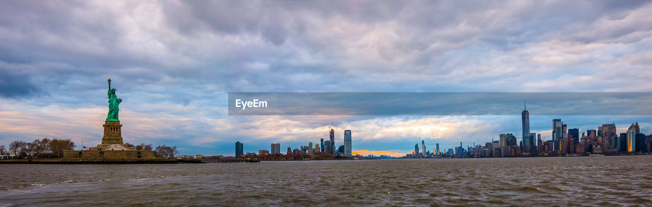 Manhattan skyline sunset panorama and cityscape from hudson and view of buildings against cloudy sky