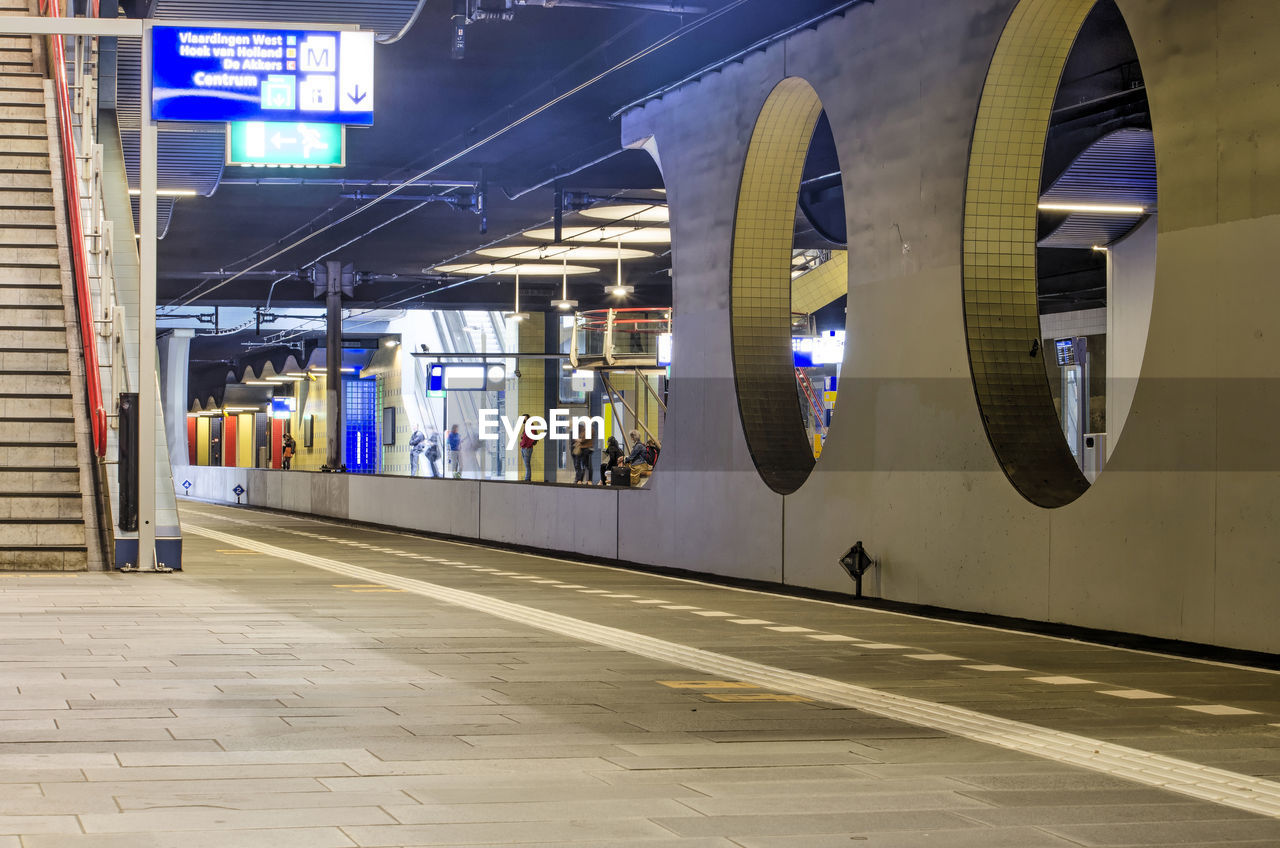 Platform, staircase and people waiting at the blaak underground railway station