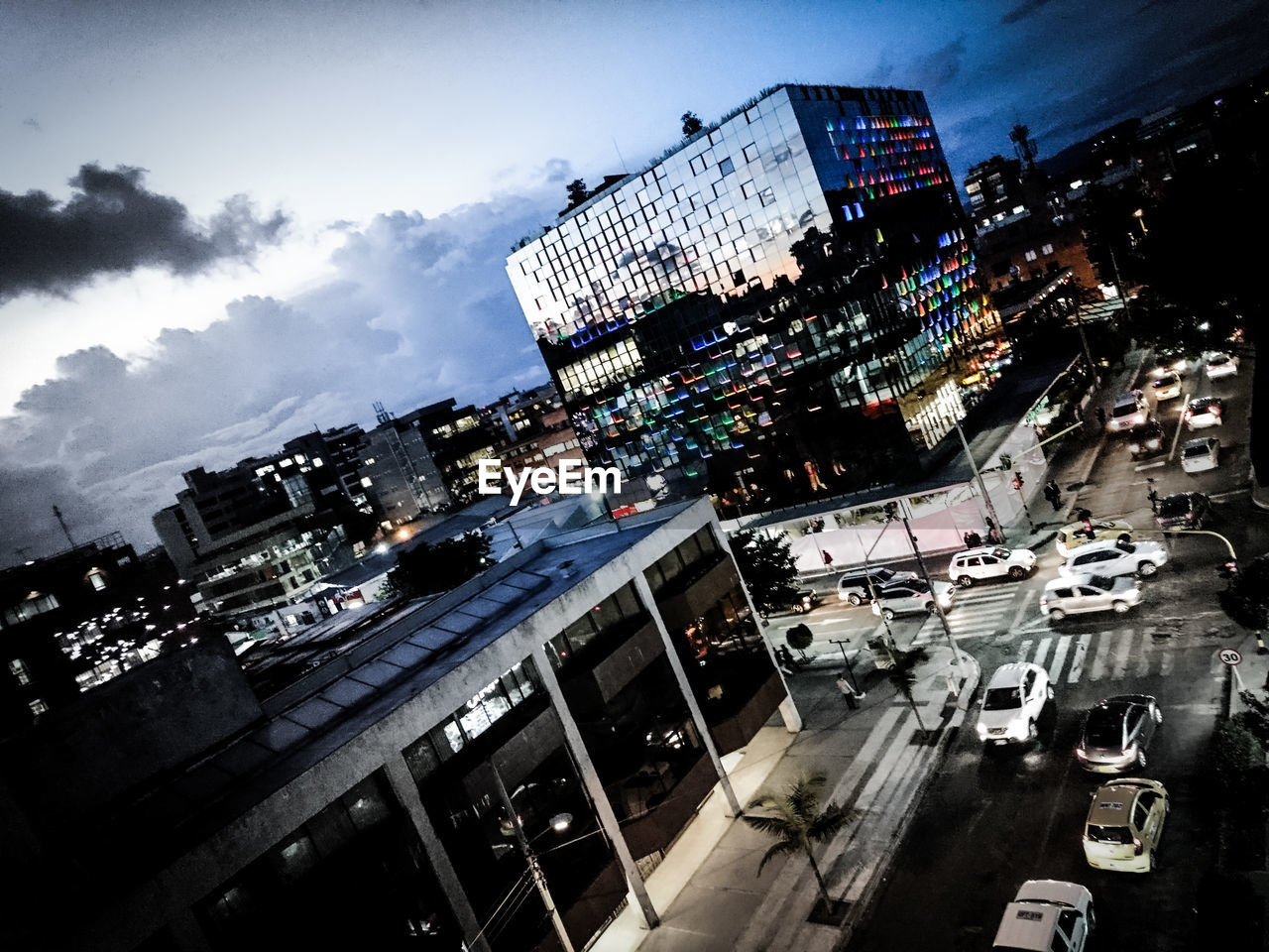 AERIAL VIEW OF ILLUMINATED CITY AGAINST SKY