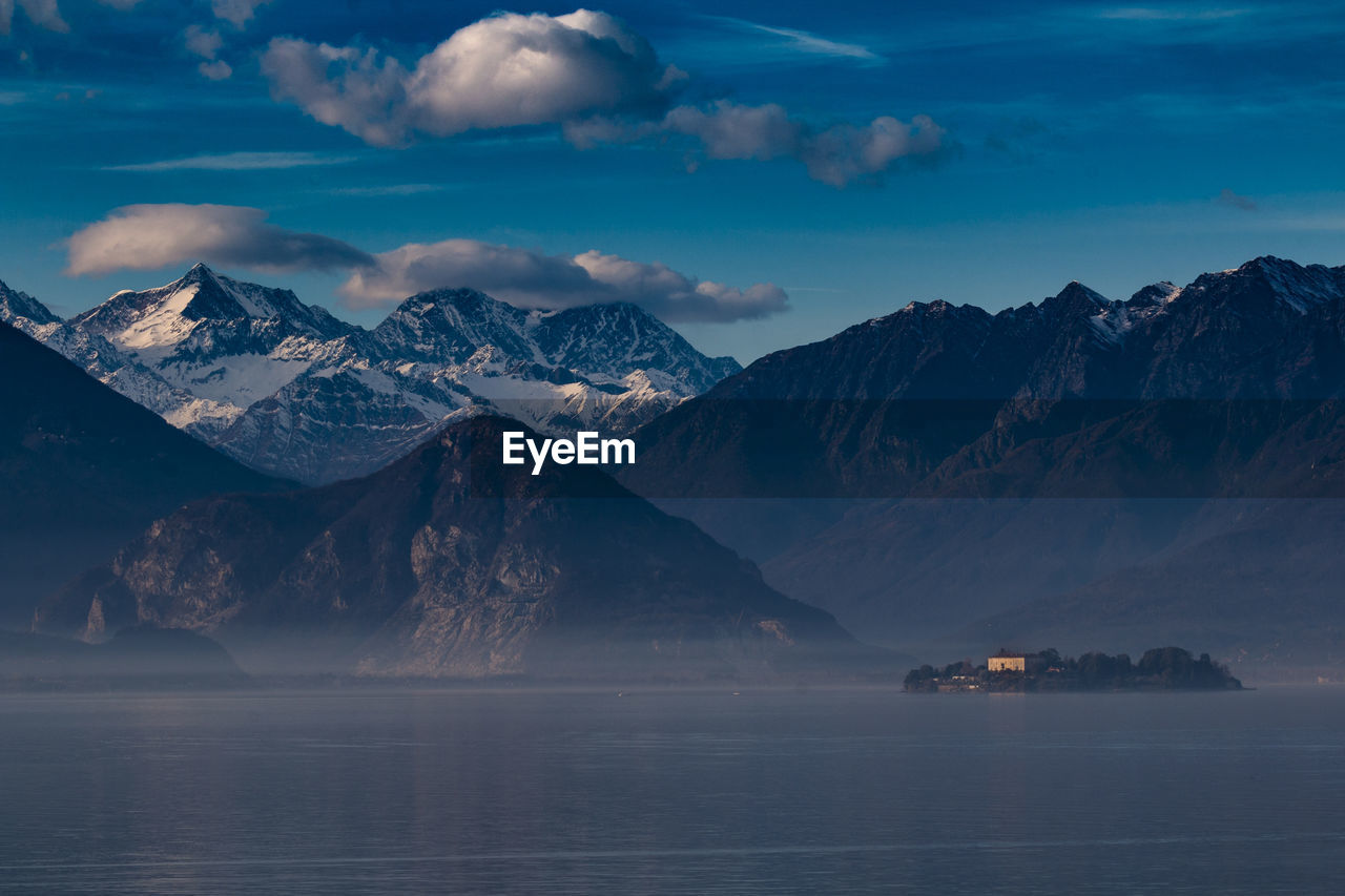 Scenic view of lake and mountains against sky