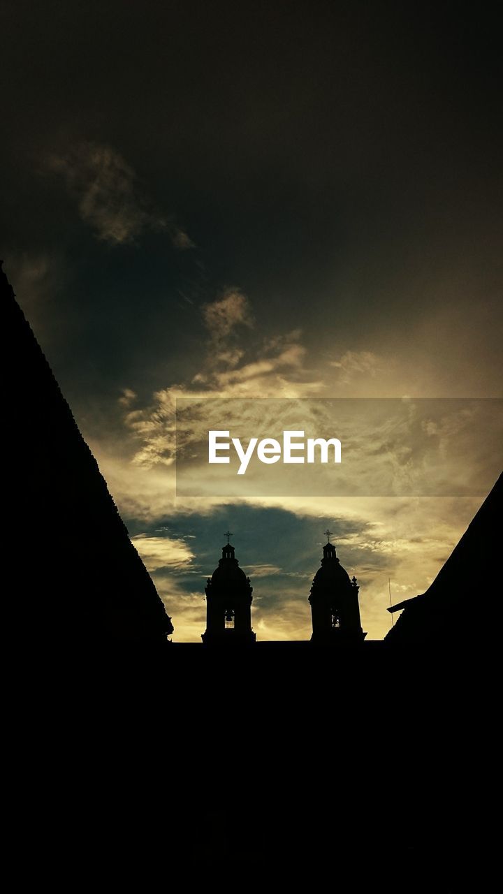 LOW ANGLE VIEW OF SILHOUETTE BUILDINGS AGAINST SKY AT SUNSET