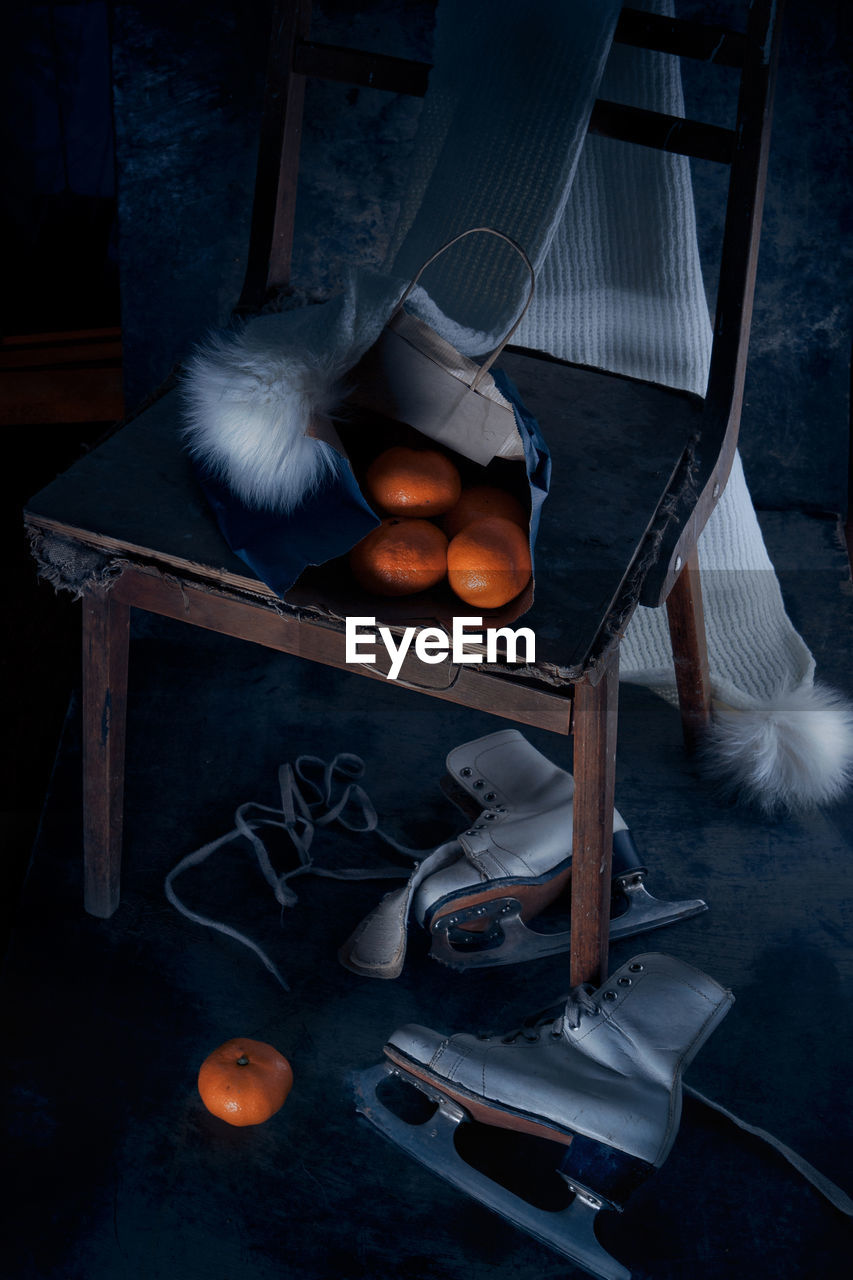 Oranges on chair by shoes