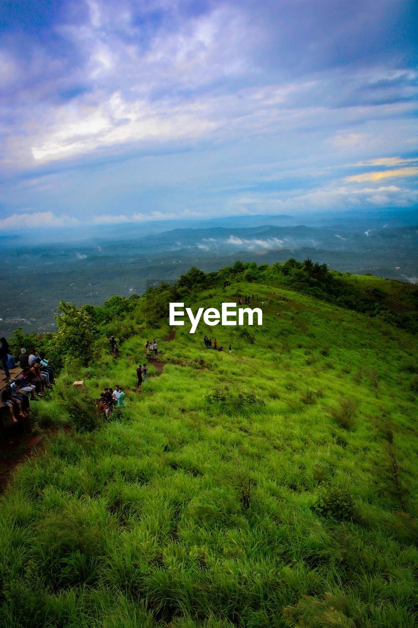 SCENIC VIEW OF GRASSY FIELD AGAINST SKY