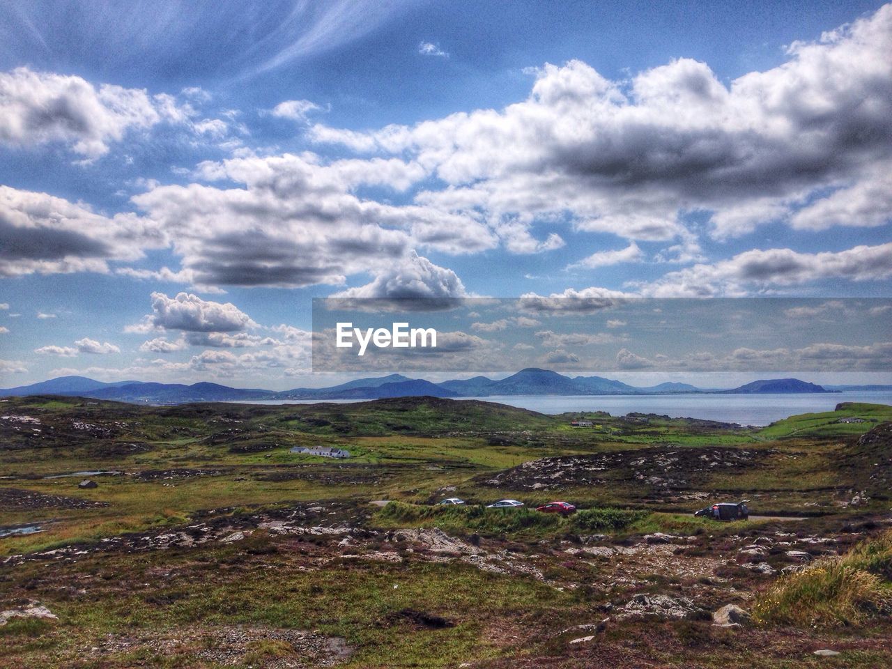 Scenic view of mountains against cloudy sky