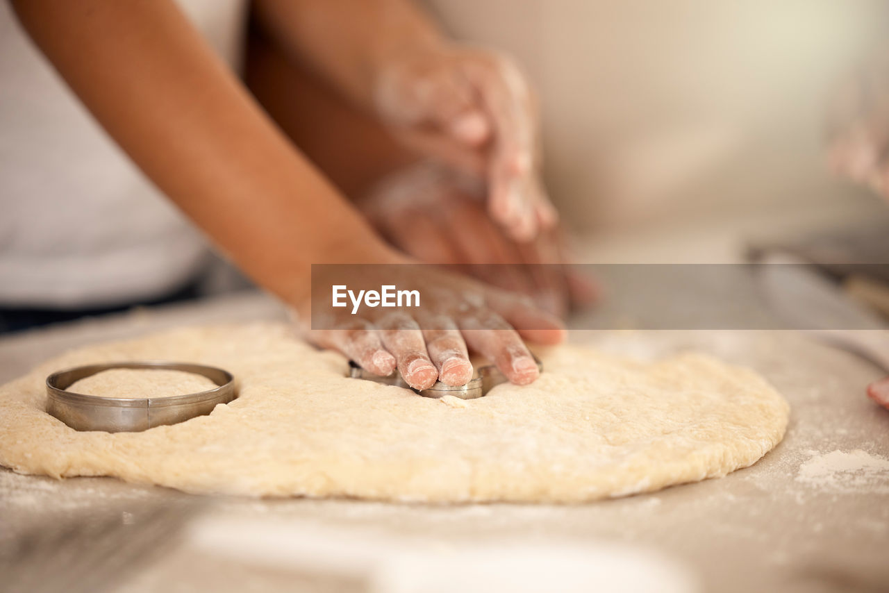 low section of woman with cookies on table