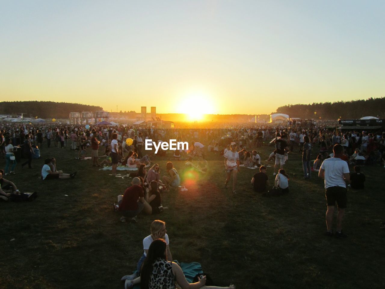 PEOPLE ENJOYING AT MUSIC CONCERT AGAINST SKY