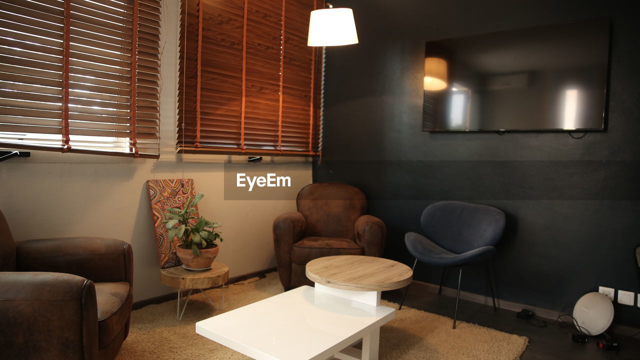 EMPTY CHAIRS AND TABLE IN KITCHEN