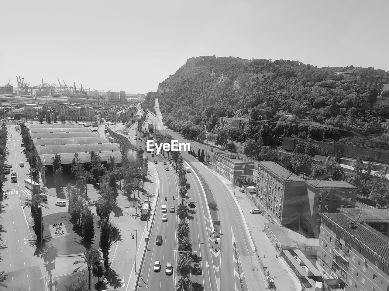 HIGH ANGLE VIEW OF CARS ON ROAD AGAINST SKY