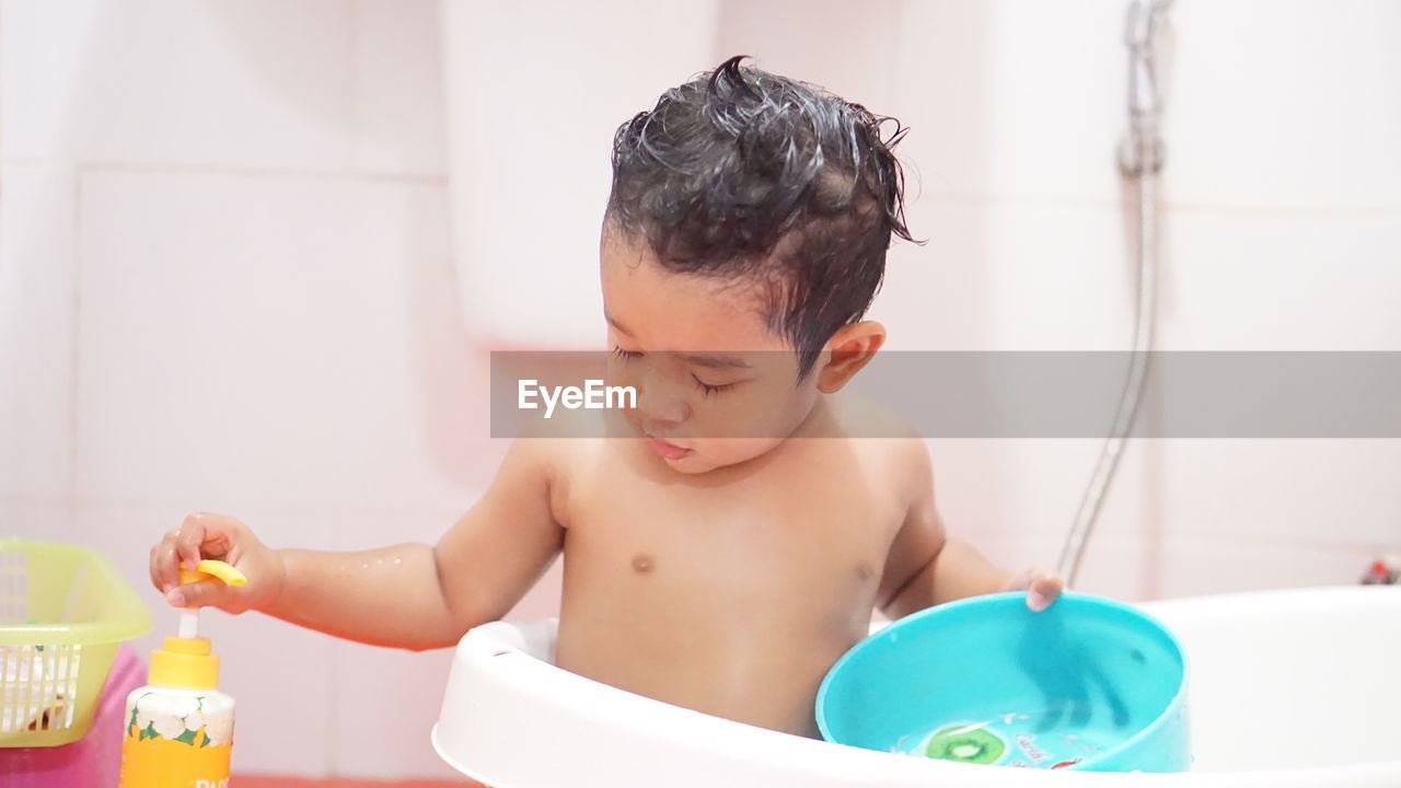 Boy looking away in bathroom