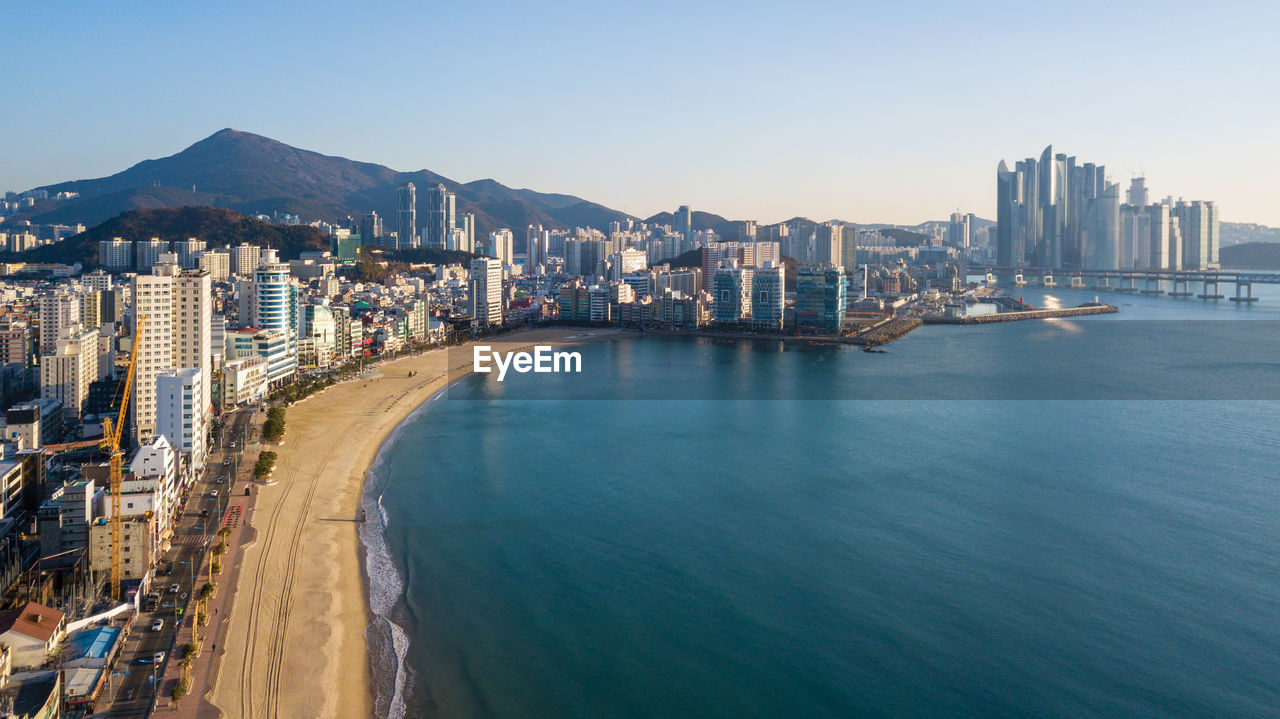 PANORAMIC VIEW OF SEA AND BUILDINGS AGAINST SKY