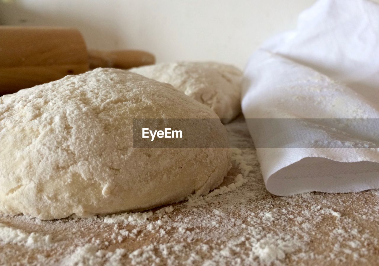 Close-up of dough and flour on kitchen counter