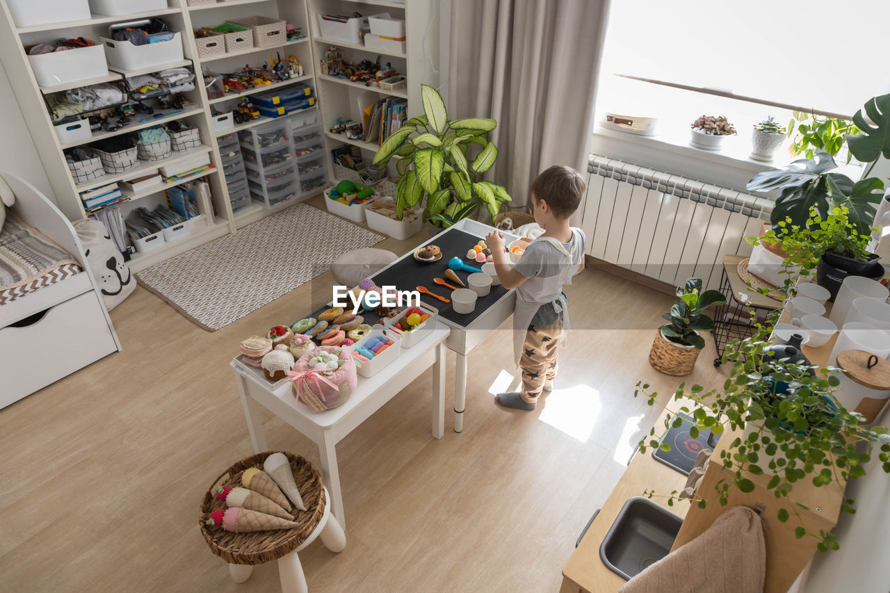 high angle view of woman sitting on table at home