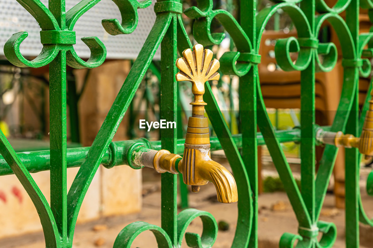 Close-up faucet on metal grate