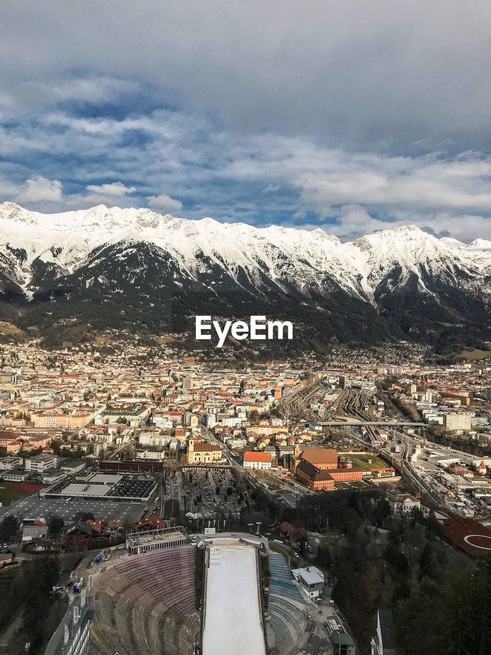 Aerial view of cityscape against snowcapped mountains