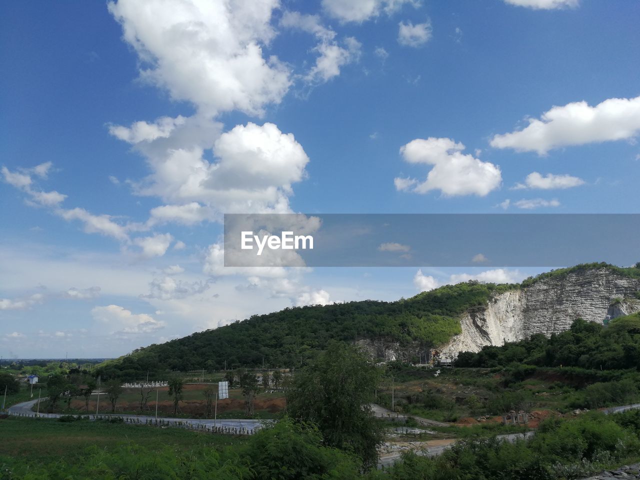 Scenic view of trees and buildings against sky