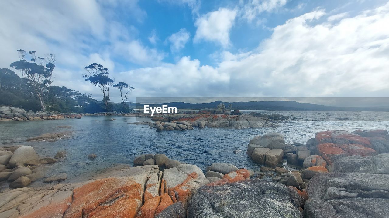 water, sky, cloud, rock, sea, scenics - nature, shore, land, nature, beauty in nature, coast, beach, environment, mountain, travel destinations, landscape, tranquility, body of water, travel, tranquil scene, no people, outdoors, bay, ocean, day, coastline, tourism, vacation, trip, holiday, idyllic, non-urban scene, wilderness