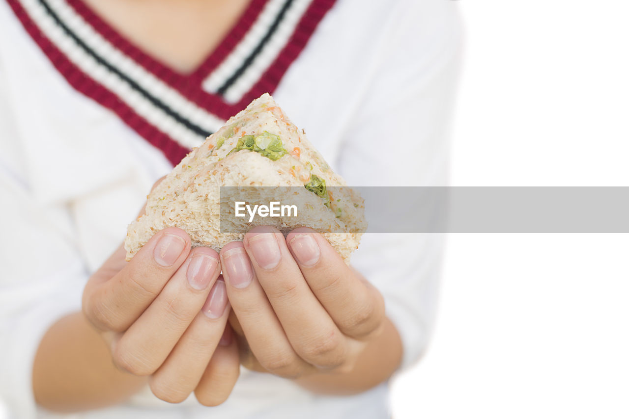 Sandwich in a woman's hand on a white background